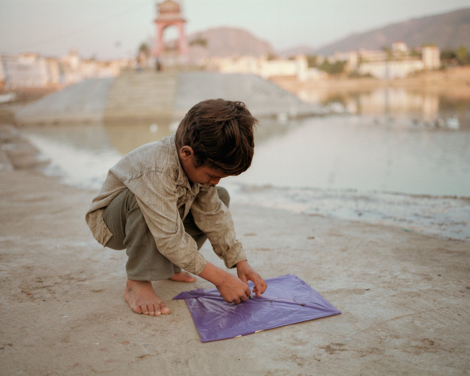 Fine art photography by Andr&eacute; Wagner: A boy and his kite in Pushkar, Rajasthan.