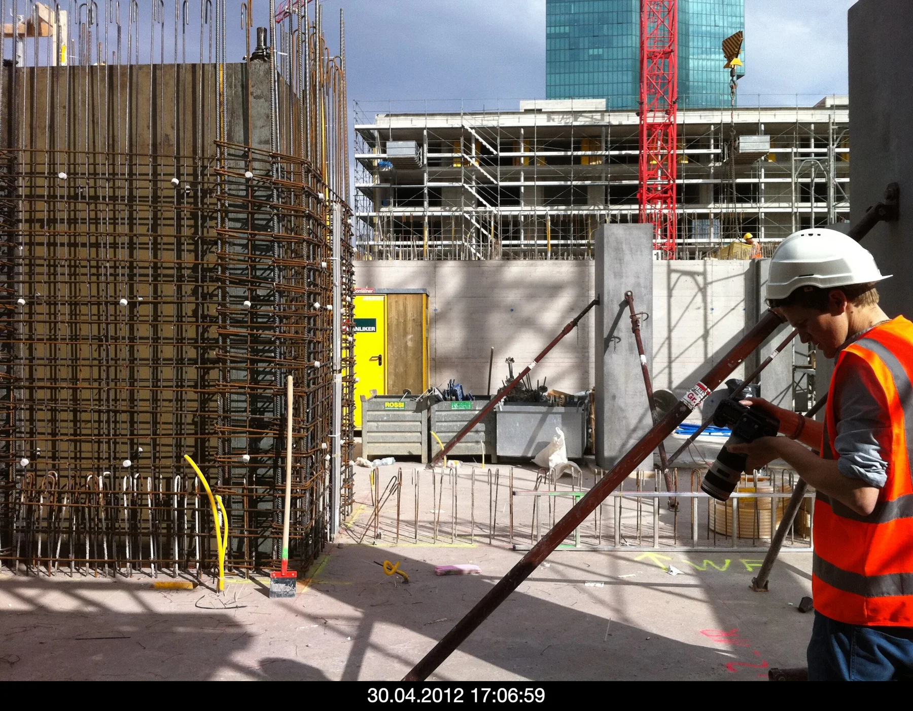 Workers and construction equipment on an open concrete floor