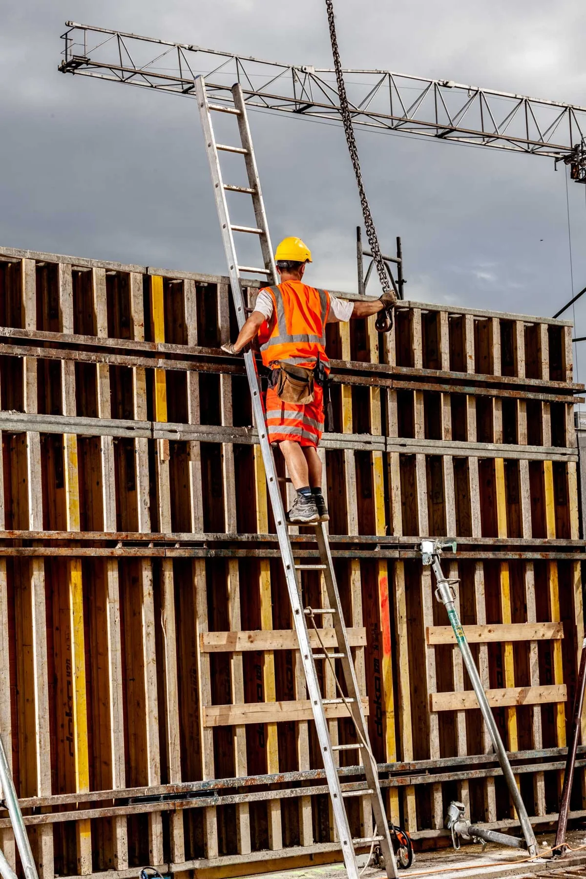 Construction workers beside formwork on a building site