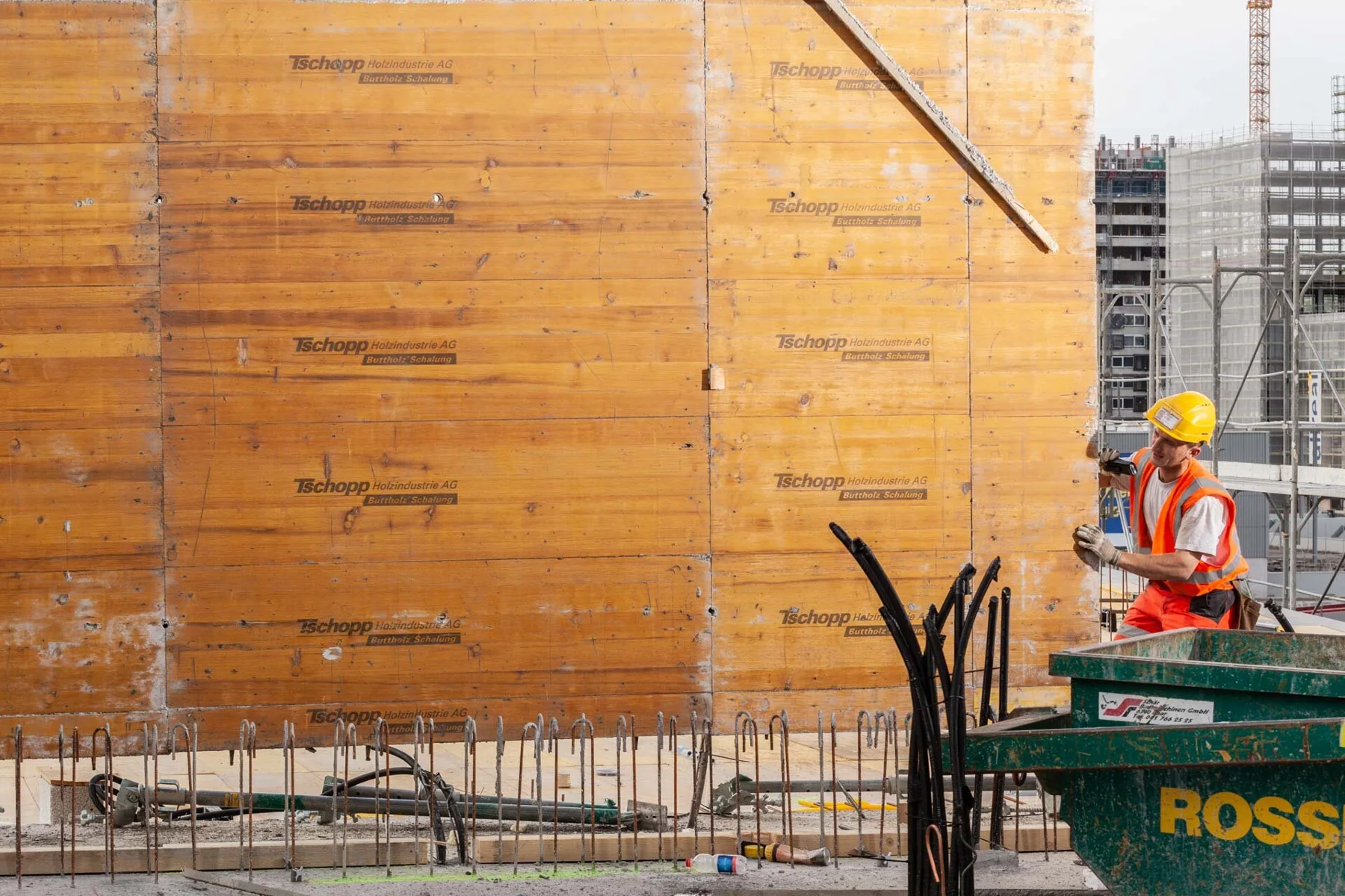 Construction workers beside formwork on a building site