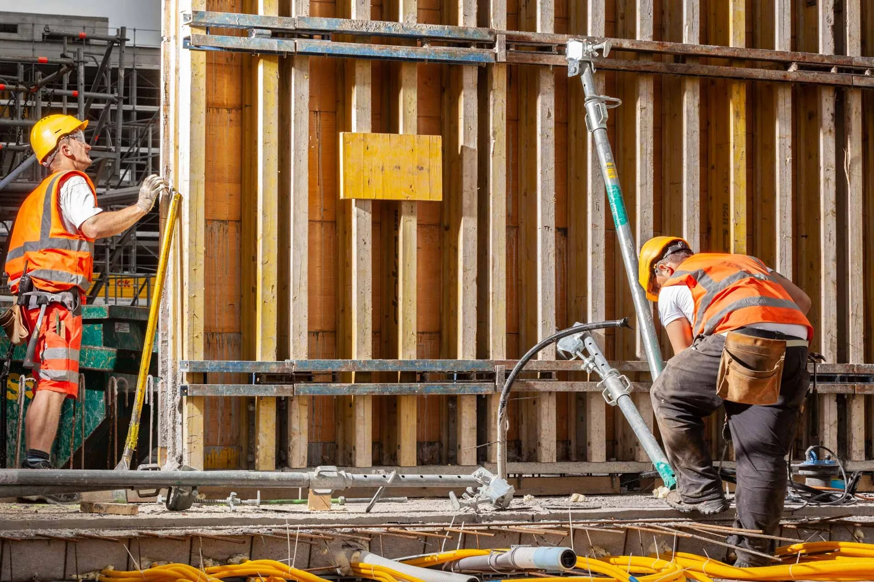 Construction workers beside formwork on a building site