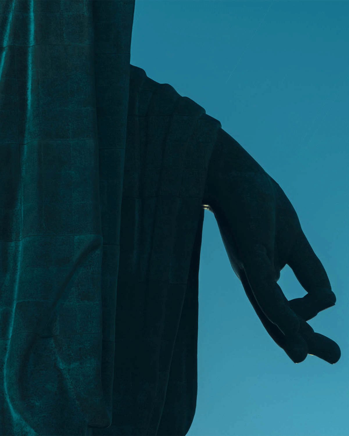 Fine art photography by André Wagner: A dark patinated hand hangs beside vertical folds of clothing — Daibutsu left hand, Japan.