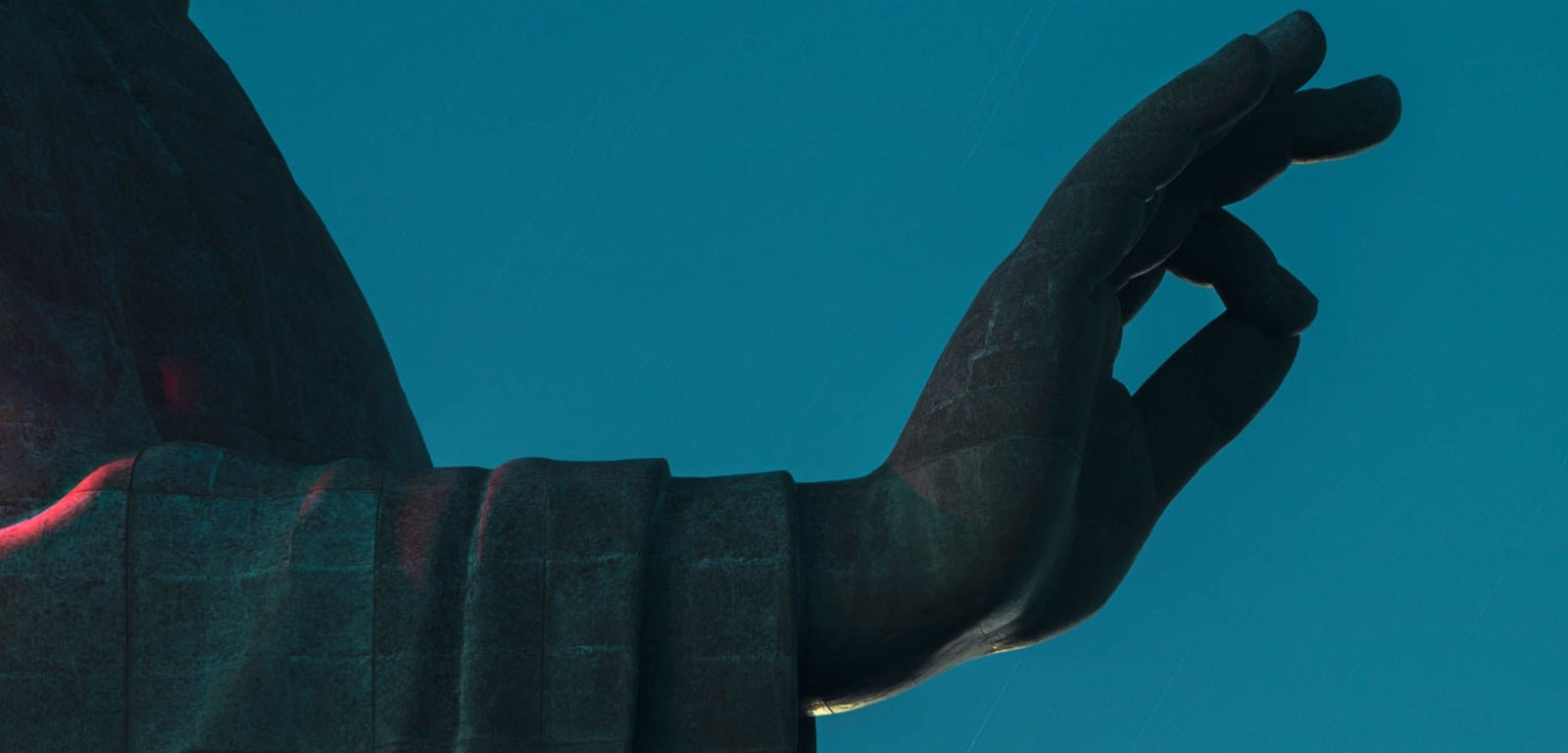 Fine art photography by André Wagner: An arm enters from the left and ends in a raised hand — Daibutsu right hand, Japan.