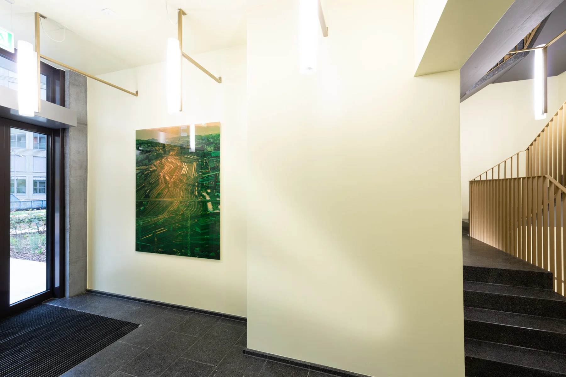 Photographic artwork with green and golden light trails in an interior