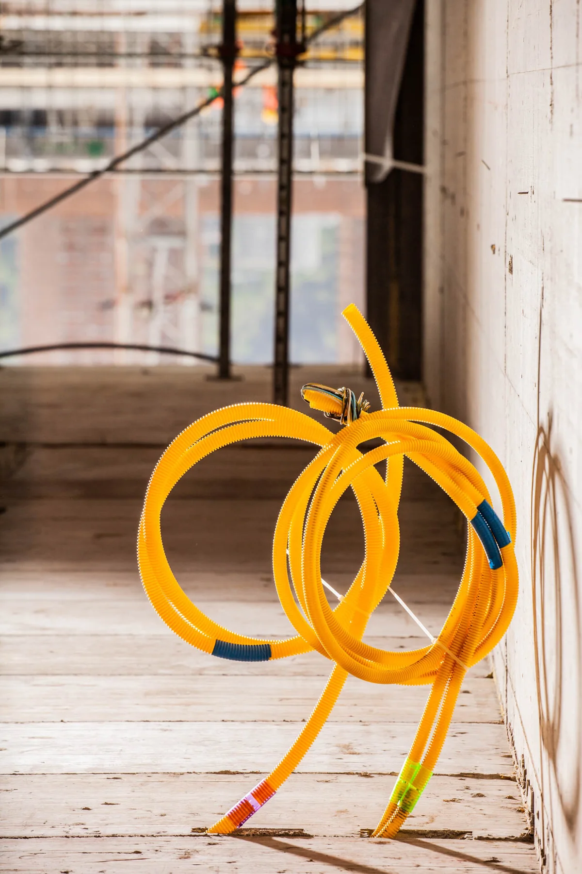 Yellow installation conduits in an unfinished building