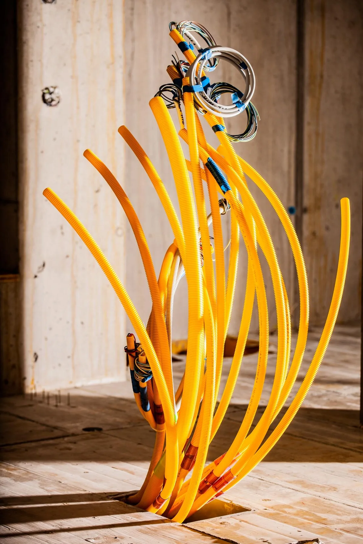 Yellow installation conduits in an unfinished building