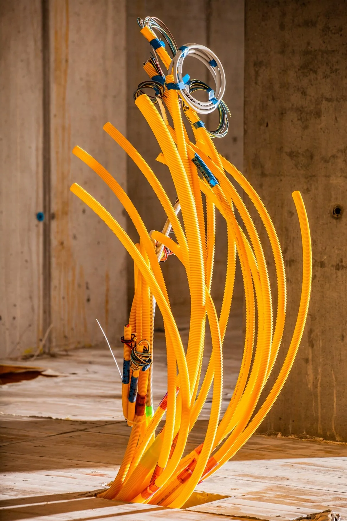 Yellow installation conduits in an unfinished building