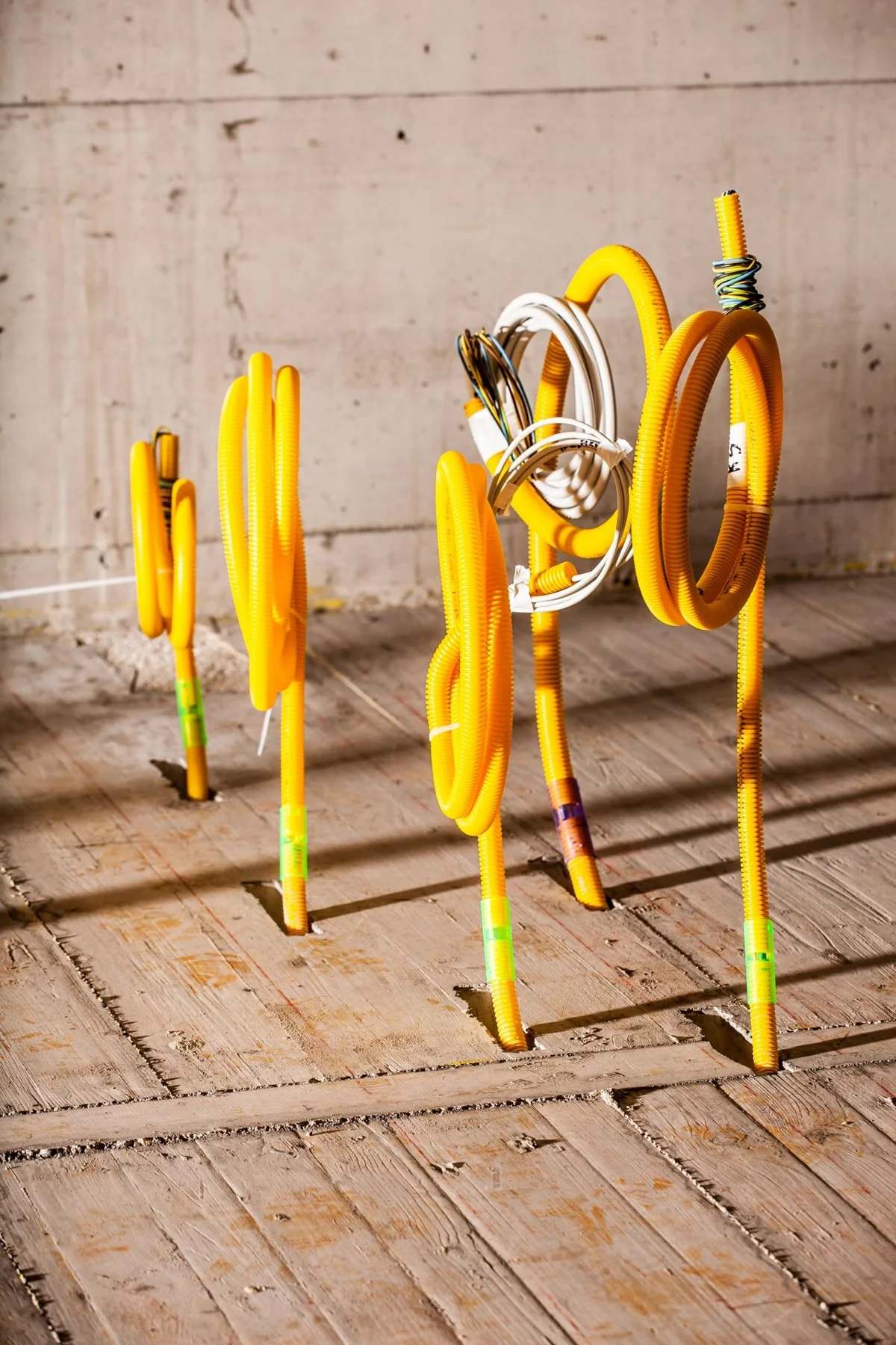 Yellow installation conduits in an unfinished building