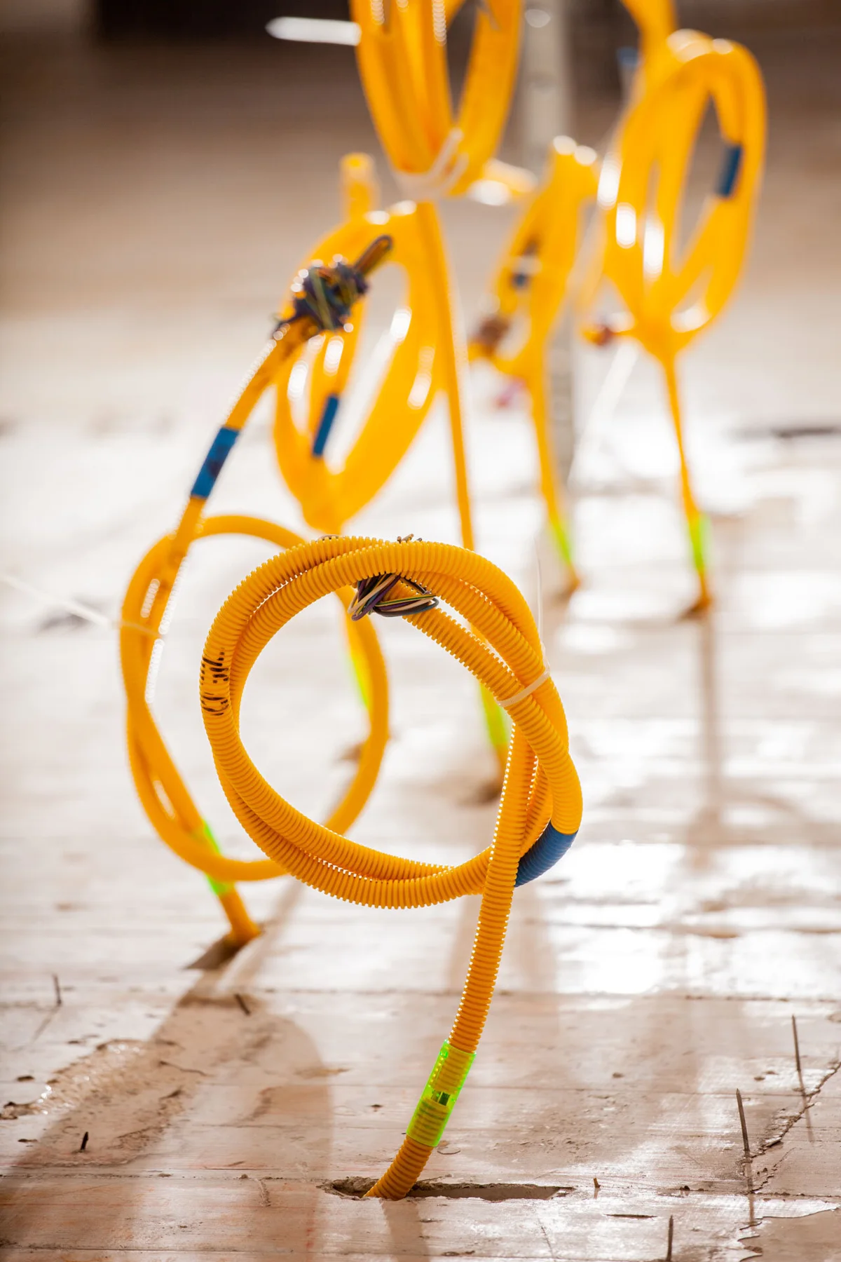 Yellow installation conduits in an unfinished building