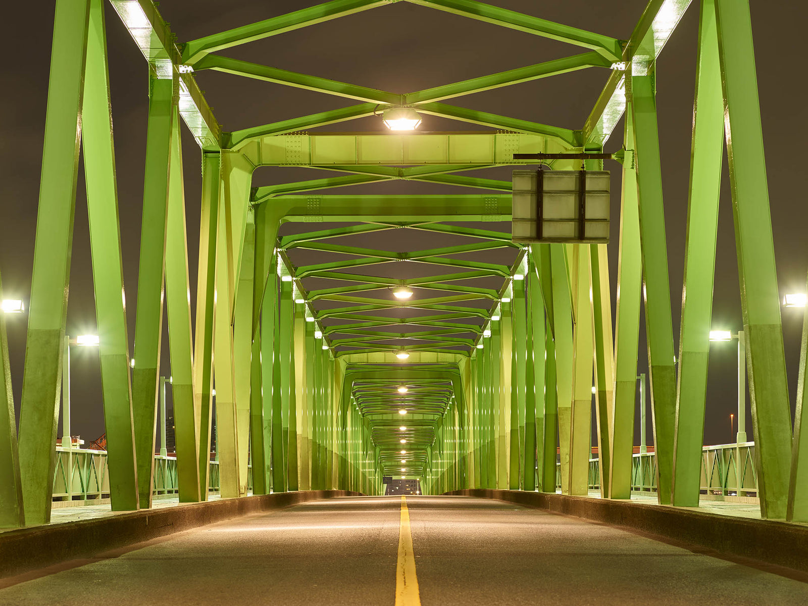 Fine art photography by André Wagner: The green steel bridge directs the eye towards an almost central vanishing point — Green bridge in tokyo, Japan.