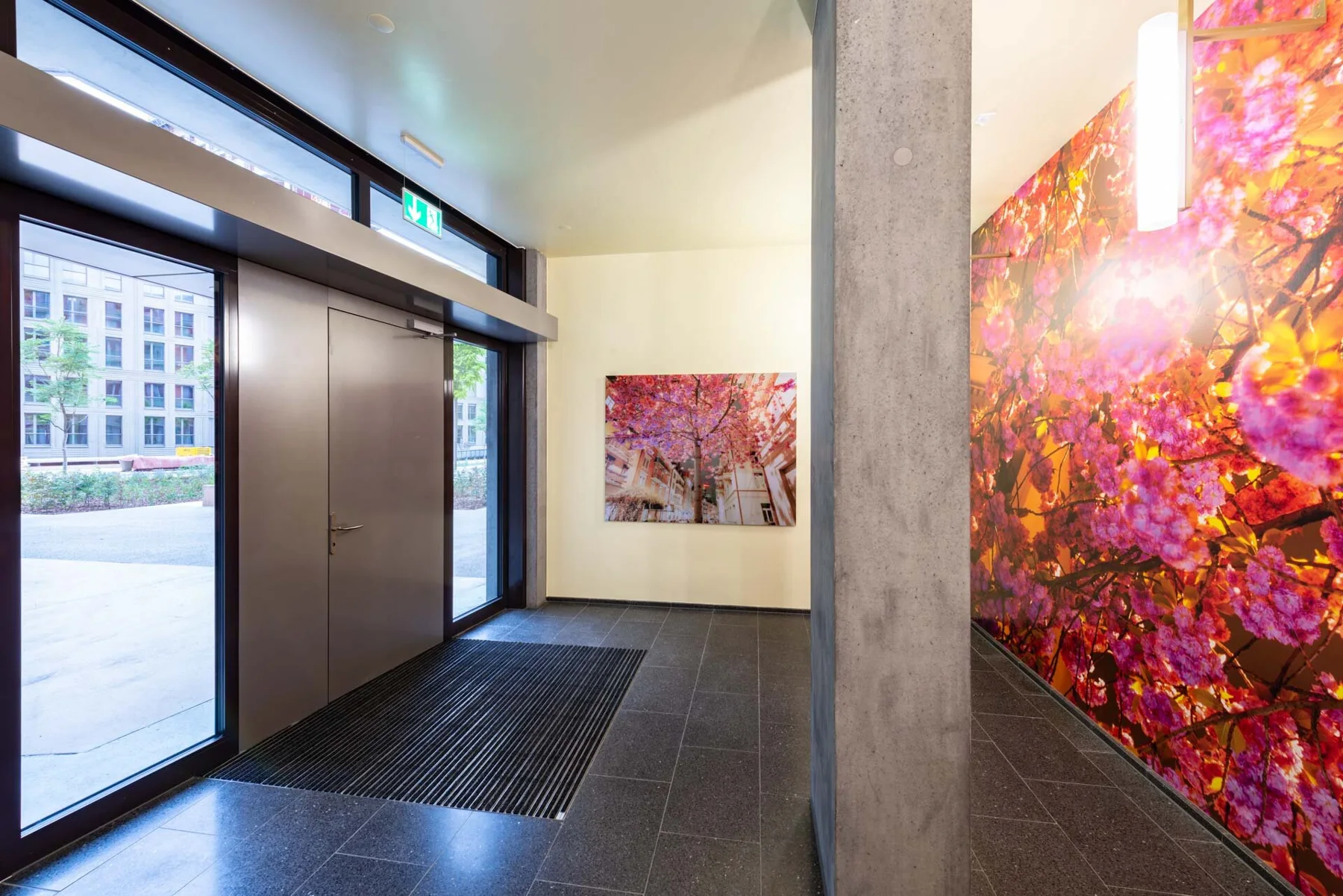 Large photographic artwork with pink and orange foliage in an entrance hall