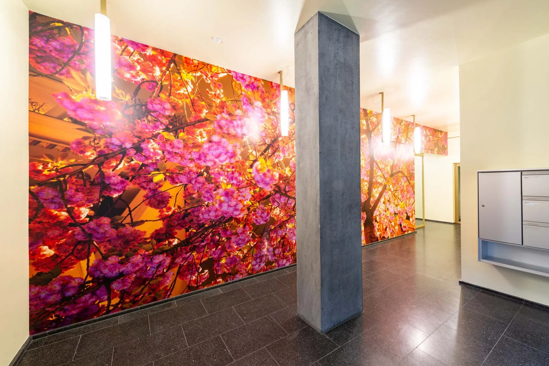 Large photographic artwork with pink and orange foliage in an entrance hall