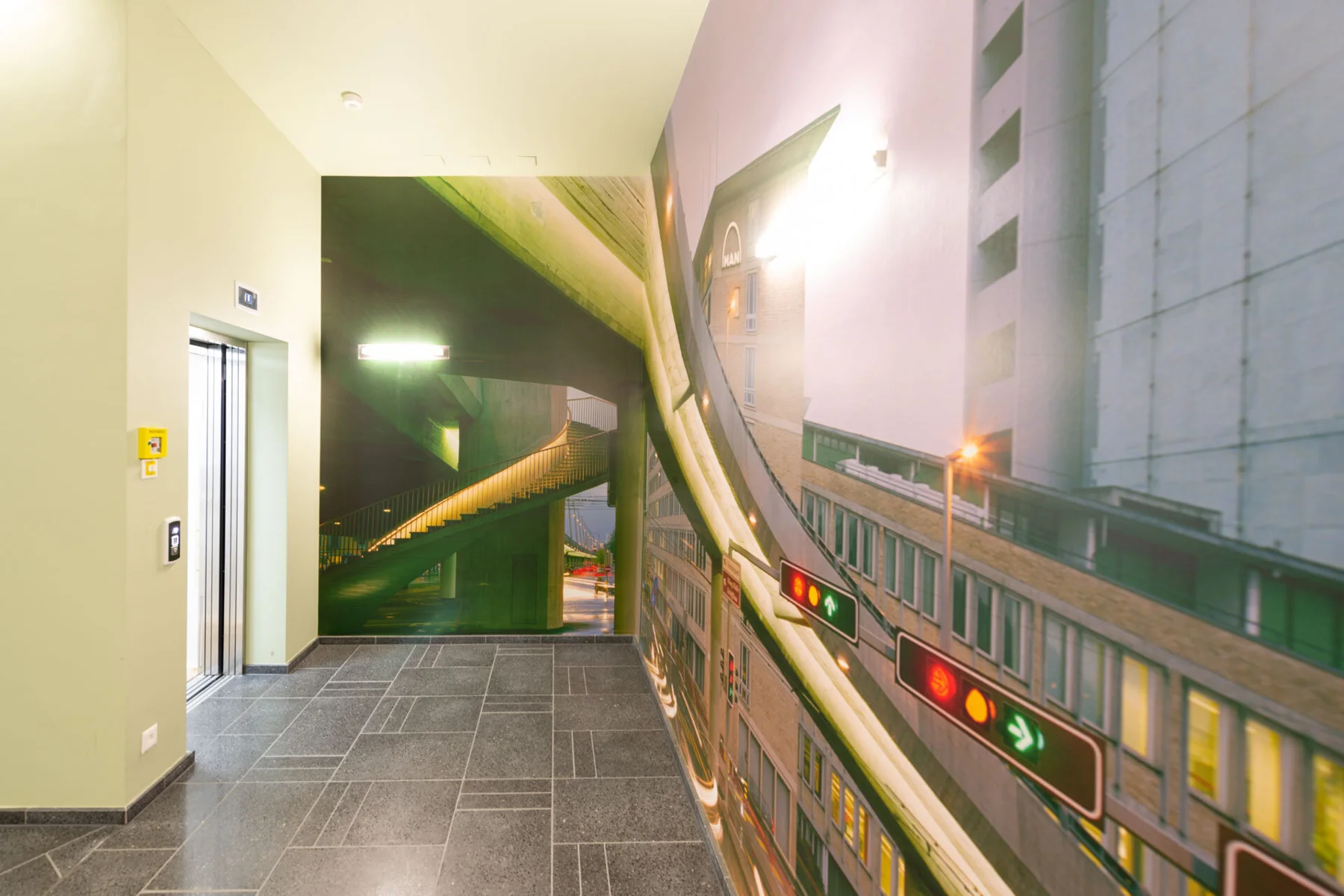 Large urban photographic artwork featuring an elevated railway in an entrance hall