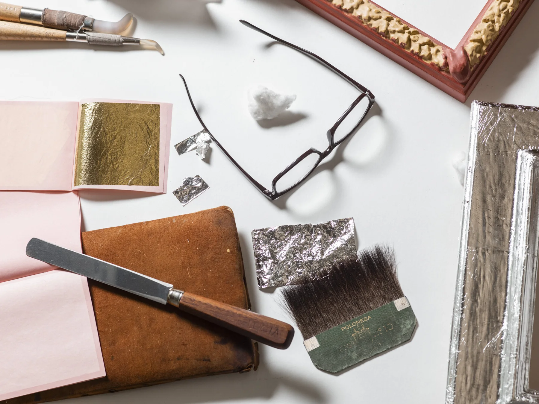 Material and colour samples with a brush and glasses on a worktable