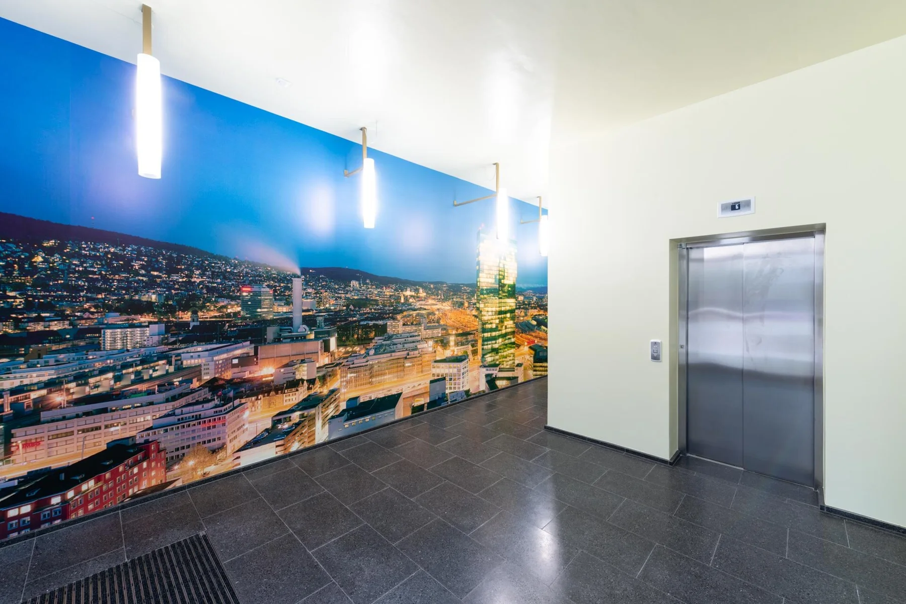 Panoramic photographic artwork of an illuminated city in an entrance hall