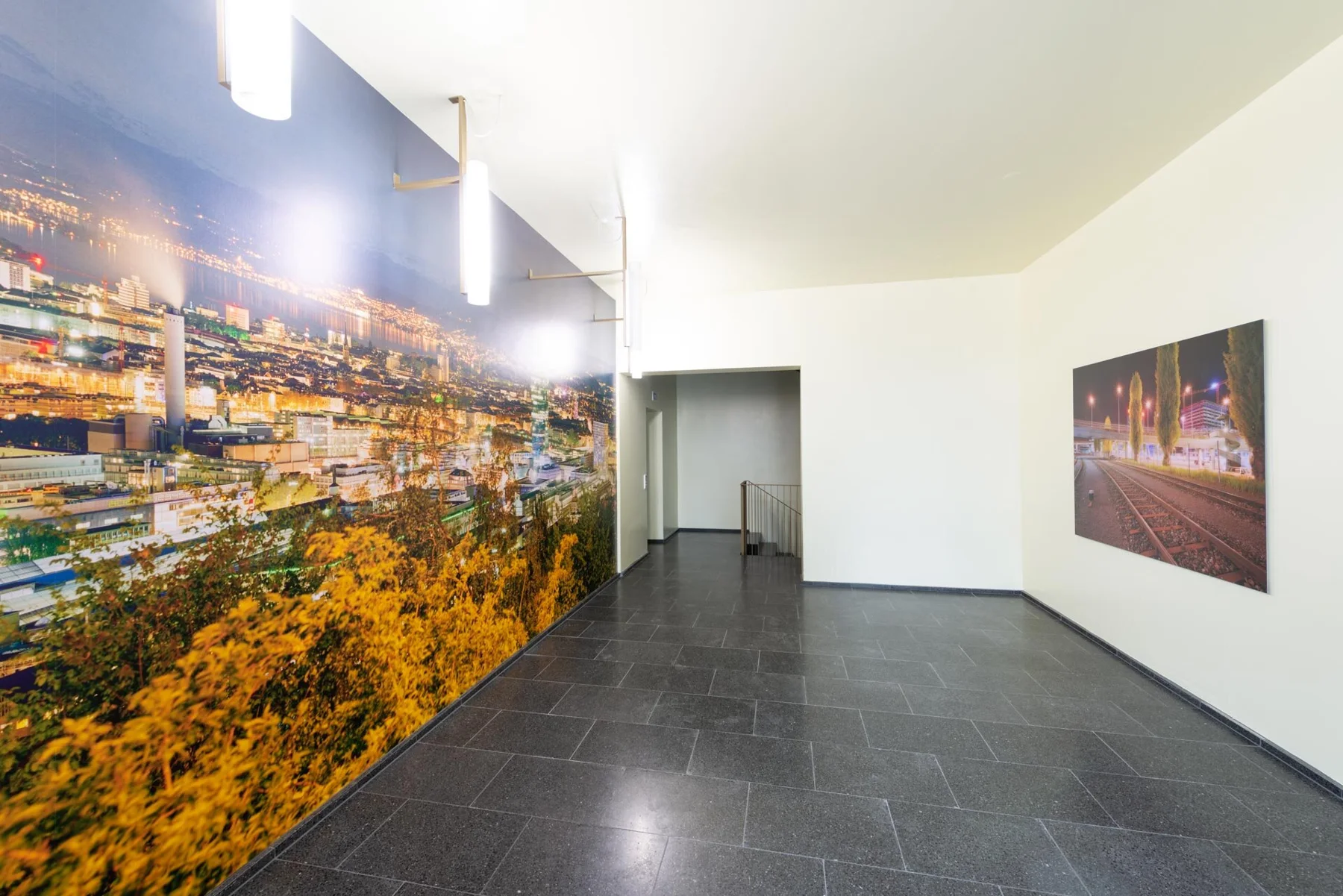Panoramic photographic artwork of an illuminated city in an entrance hall